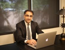 Dr. Azadi sitting at desk